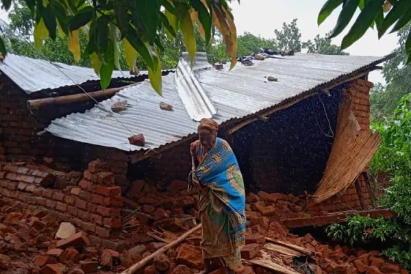 An elderly woman in front of her destroyed house in TA Mlumbe Zomba. Credit: CADECOM