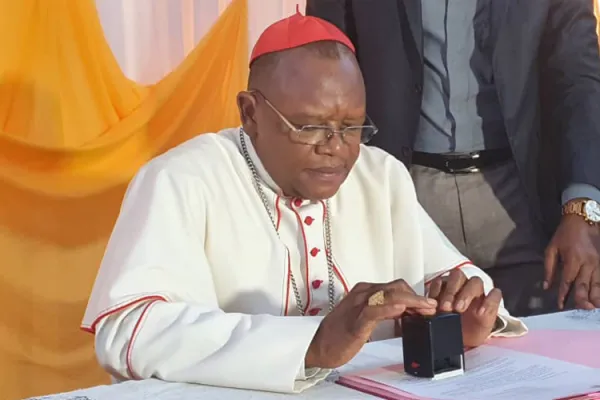Fridolin Cardinal Ambongo signing the decree creating Omnia Catholic University in DR Congo's Kinshasa Archdiocese. Credit: Courtesy Photo