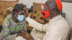 Jean Pierre Cardinal Kutwa granting his blessings to Mariatou Koné who was recently appointed Minister for Education and Literacy in Ivory Coast. Credit: Courtesy Photo