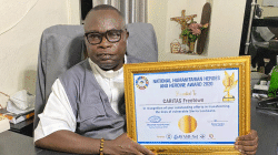 Fr. Peter Konteh with the award received by Caritas Freetown during the commemoration of the World Humanitarian Day on August 19. / Caritas Freetown