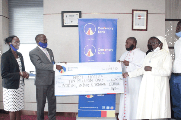 Centenary Bank Managing Director Fabian Kasi (2nd Left), Centenary , handing over a dummy cheque worth UGX10 million (US$2,700.00)  to the Nkozi Hospital Team.