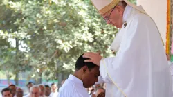 Pope Francis lays hands on a Bangladeshi deacon as he ordains him to the priesthood during a Dec. 1, 2017, Mass in Dhaka. Vatican Media.