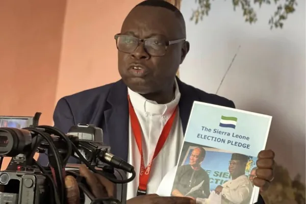 Caritas Freetown Executive Director Fr. Peter Konteh presents the Sierra Leone Election Pledge. Credit: Caritas Freetown Media team