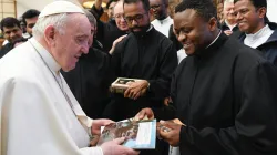 Fr. Banyuzukwabo Laurianus Tuyisabe explains contents of his books on Immigration to Pope Francis on February 26. Credit: Fr. Banyuzukwabo Laurianus Tuyisabe