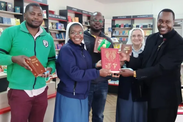 Fr. Paul Ndungu of Kenya's Nyahururu Diocese (right), the first Priest to purchase the newly published Swahili Liturgical Books on 14 August 2021 at the Paulines Communication Centre in Nairobi, pose for a photo alongside two Daughters of St Paul, Sr. Clara Zaniboni (next to Fr. Paul) and Sr. Metrine Nafula (between two customers). Credit: Sr. Olga Massango/Daughters of St Paul, Nairobi