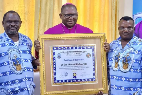 Members of the Catholic Men Association (CMA) in Cameroon’s Diocese of Buea present a certificate of appreciation to Bishop Michael Miabesue Bibi. Credit: Buea Diocese