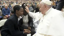 Pope Francis blesses a young woman during a general audience in the Vatican's Paul VI Hall in December 2022. | Vatican Media.