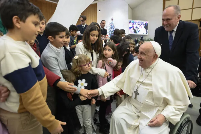 Pope Francis greets children of Vatican employees during the annual Christmas gathering in the Vatican's Paul VI Hall, Dec. 21, 2024.