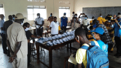 Uganda's Cabinet Minister in charge of Refugees, Hillary Onek  inspecting the production of  Face Masks at the Don Bosco Vocational Training Center (VTC). / Don Bosco Palabek Refugee Services