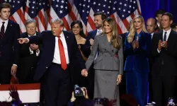 Republican presidential nominee former president Donald Trump points to supporters with former first lady Melania Trump during an election night event at the Palm Beach Convention Center on Nov. 6, 2024, in West Palm Beach, Florida. / Credit: Joe Raedle/Getty Images