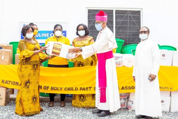 Archbishop Palmer-Buckle, Vice President of the Ghana Catholic Bishops’ Conference receiving a donation from  Mrs. Asor Anyimadu-Antwi, on behalf of the  National Union of Past Students of Holy Child School. / Global Newswatch Media