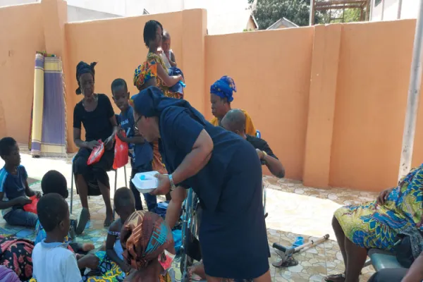 Sr. Olivia Umoh, DC, Director of Safe-Child Advocacy (SCA), a Humanitarian Organisation owned by the Archdiocese of Kumasi, sharing food to Children with disability and their mothers at a recent party for the vulnerable. / SCA.