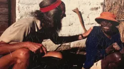 An undated photo of John Bradburne (L) with a leper. / John Bradburne Memorial Society