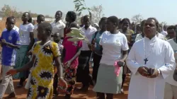 Fr. Lazar Arasu, the Director of Don Bosco Palabek Refugee Services with refugees in Uganda camp.