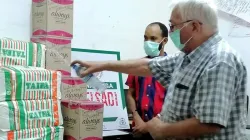 Malindi  Diocesan Administrator, Fr. Albert Buijs blesses items for the vulnerable people in the diocese. Looking on is Executive Secretary of the Catholic Justice and Peace Commission of the diocese, Moses Mpuria / CJPC Malindi/ Moses Mpuria