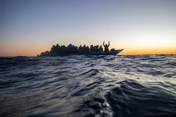 Migrants on an overcrowded boat awaiting help/ Credit: Courtesy Photo