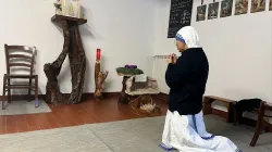 A sister kneels before the tabernacle after inviting a group of women donating Christmas gifts to pray in the Missionaries of Charity house in Rome. / Credit: Courtney Mares/CNA