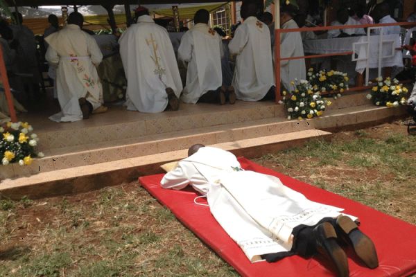 A seminarian lays prostrate during his diaconate ordination / Bishop James Maria Wainaina/ Facebook