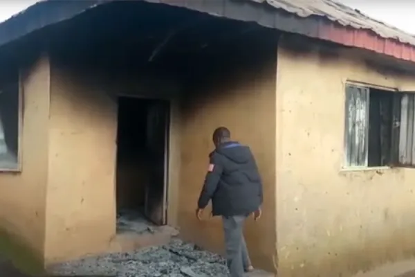 A ma enters a building at a Nigerian orphanage which was attacked by Fulani herdsmen on August 2. Credit: Religious Freedom Coalition