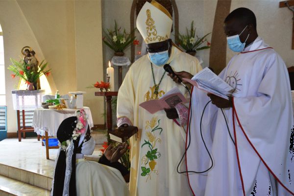 Bishop George Desmond Tambala of the Diocese of Zomba handing over the Bible to Sr. Luciette Marie after she had taken her final vows. / Diocese of Zomba