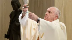 Pope Francis celebrates Mass May 1, 2020, with a statue of St. Joseph in the background. Credit: Vatican Media