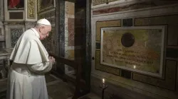 Pope Francis prays near the tomb of Father Pedro Arrupe, SJ, superior general of the Society of Jesus between 1965 and 1981, during a Mass at the Jesuit Church of the Most Holy Name of Jesus, known as the “Gesu” in Rome, Italy, on March 12, 2022, on the 400th anniversary of the canonization of St. Ignatius of Loyola, the society’s founder. / Credit: Vatican Media/Abaca/Sipa USA/Sipa via AP Images