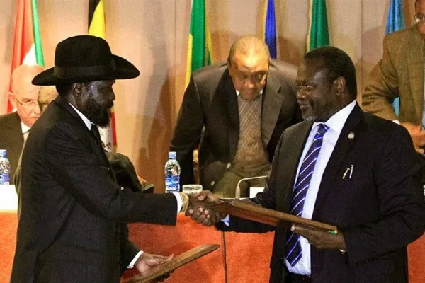 South Sudan's President Salva Kiir (left) and Vice-president Riek Machar (right) shake hands at the signing of the Revitalized Agreement on the Resolution of Conflict in South Sudan (R-ARCSS) in September 2018. Credit: Courtesy Photo
