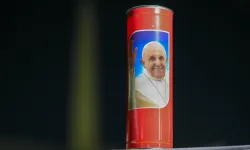 A candle with an image of Pope Francis on it sits in St. Peter’s Square at the Vatican duirng a rosary prayer service for the Holy Father on Thursday, March 6, 2025. / Credit: Daniel Ibañez/CNA