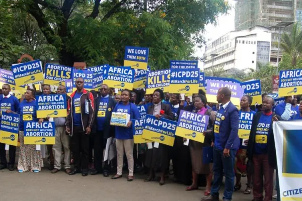 Protesters holding placards in Nairobi against ICPD25 on the eve of the convention on November 11, 2019