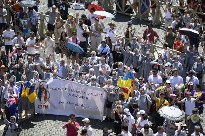 Many people wore hats or held umbrellas to shade themselves from the sun's rays during Pope Francis' Angelus address July 14, 2024. Despite the heat, the crowd still gave an enthusiastic welcome to the pope when he appeared at the window of the Apostolic Palace.