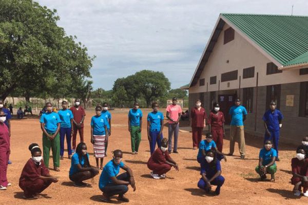 Nurses and trainee health care-givers at Mary Ward Primary Health Care Clinic in Rumbek, South Sudan pose for a photo outside the Clinic on the eve of International Nurses Day. / Sr. Orla Treacy