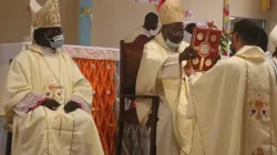 Bishop Carlassare receives the Holy Bible from Gabriel Cardinal Zubeir Wako during the March 25 Episcopal Ordination held at Holy Father Cathedral of the Diocese of Rumbek. Credit: Courtesy Photo