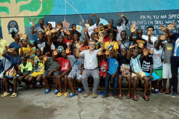 Fr. Jorge Mario Crisafulli with Street children at the Don Bosco Fambul in Freetown, Sierra Leone. / Salesian Missions in Africa