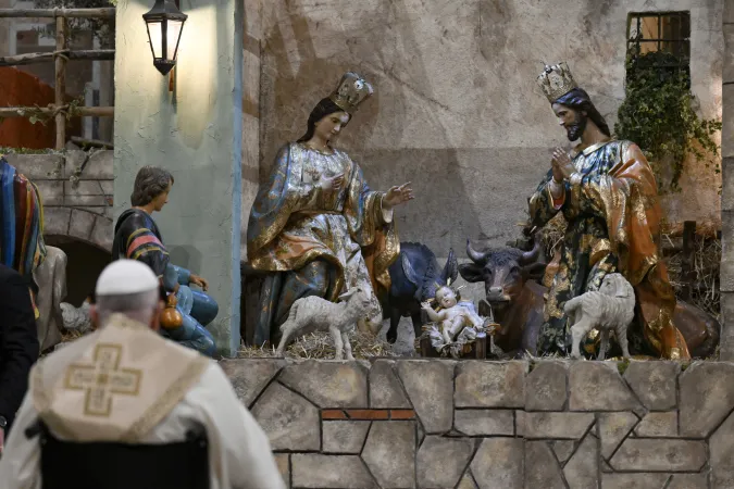 Pope Francis stopped to pray at the Nativity scene in St. Peter's Basilica after Christmas Mass on Dec. 24, 2024.