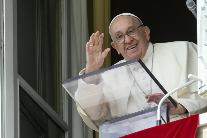 Pope Francis waves from a window of the Apostolic Palace at the crowds gathered in St. Peter's Square for his weekly Angelus address on Sunday, Sept. 22, 2024.