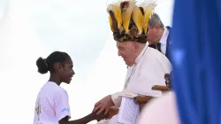 Pope Francis wears a traditional head dress as greets a young girl in Vanimo, Papua New Guinea, Sept. 8, 2024 / Vatican Media