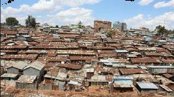 Image showing an open sewer running behind numerous corrugated houses at Mukuru kwa Njenga in Nairobi, Kenya. / courtesy