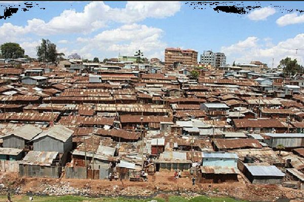 Image showing an open sewer running behind numerous corrugated houses at Mukuru kwa Njenga in Nairobi, Kenya. / courtesy