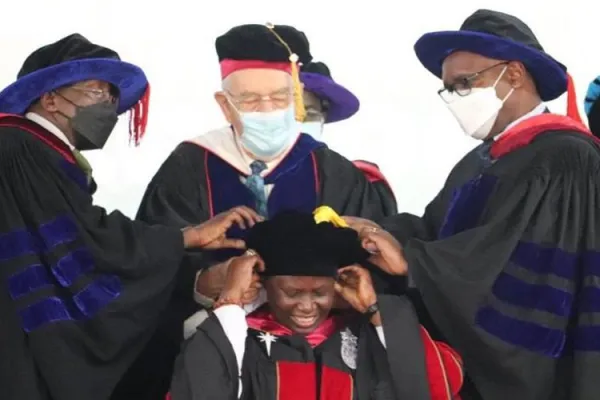 Sr. Prof. Agnes Lucy Lando being gowned by the Founder of Daystar of Daystar University, Dr. Donald K. Smith (centre), assisted by Prof. Abraham Waithima (right) and Prof. Michael Bowen (Left) on 24 February 2022. Credit: Daystar University, Corporate Affairs