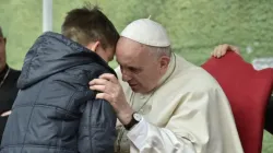 Pope Francis listens to a boy called Emanuele at St. Paul of the Cross parish, Rome, on April 15, 2018. Vatican Media.