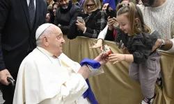 During his audience with Italian Catholic educators, Pope Francis interacts with a young girl at the Paul VI Audience Hall at the Vatican on Jan. 4, 2025. / Vatican Media