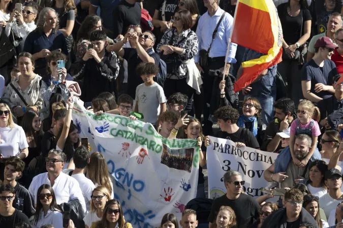 Crowds in a sunny St. Peter's Square watch Pope Francis as he leads the Angelus prayer from a window of the Apostolic Palace on Nov. 3, 2024.