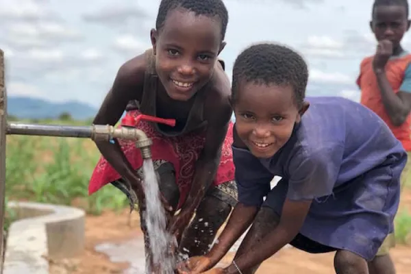 Some children at a solar-powered well sponsored by Water 4 Mercy. Credit: Water 4 Mercy