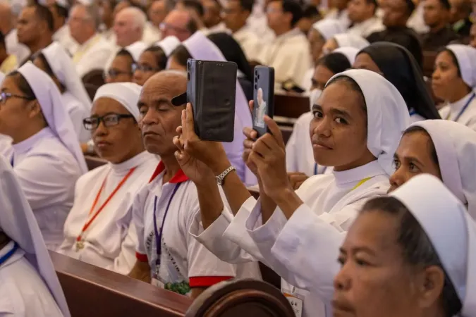 Sisters take a picture or Pope Francis at the meeting with bishops, priests, deacons, consecrated persons, seminarians at the Cathedral of the Immaculate Conception in Dili, East Timor, Sept. 10, 2024.