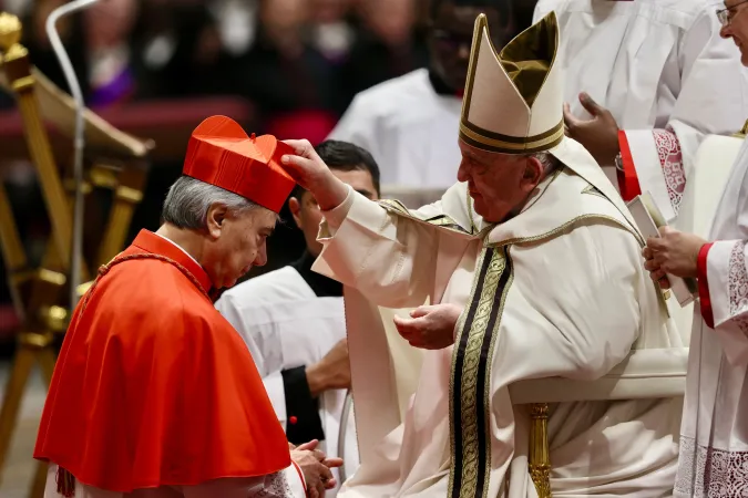 Pope Francis places the red biretta on Cardinal Domenico Battaglia, archbishop of Naples, during the consistory for the creation of 21 new cardinals in St. Peter's Basilica, Dec. 7, 2024.